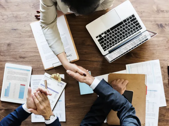 Business people shaking hands together