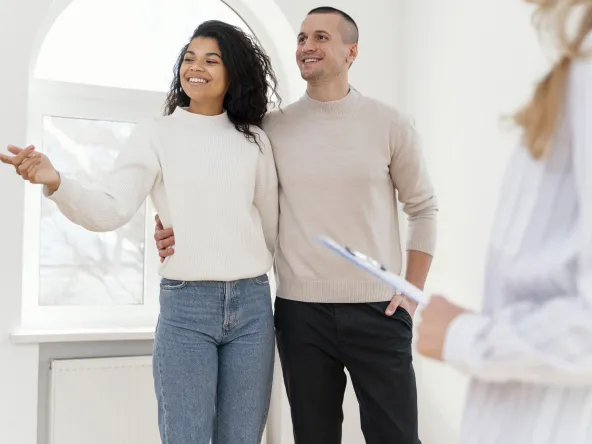 smiley couple seeing new house with realtor
