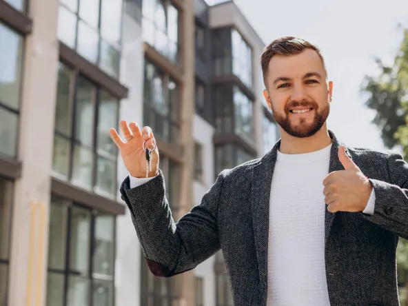 Young man with keys just bought new appartment