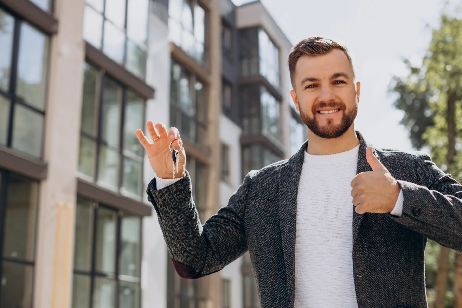 Young man with keys just bought new appartment